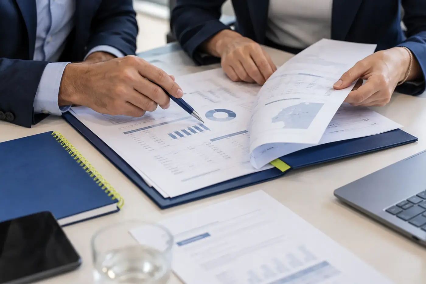 Reviewing a report with charts at a meeting table